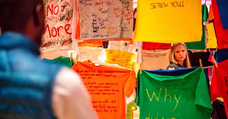 Visitors walking through the clothesline display